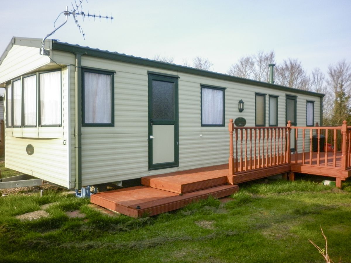 Static caravan with wooden deck
